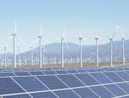Panoramic view of a renewable energy landscape with wind turbines and solar panels in a green field, symbolizing sustainable energy solutions.